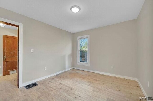 269 S Main St, Wellsville, NY 14895 - spare room with light wood-style floors, visible vents, and baseboards