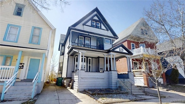 victorian-style house with a balcony and covered porch
