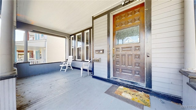 doorway to property featuring covered porch