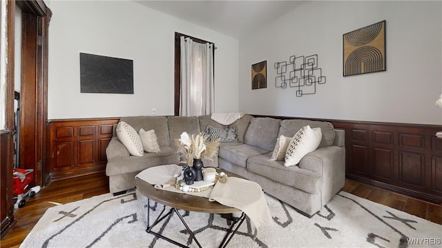 living room with a wainscoted wall and wood finished floors