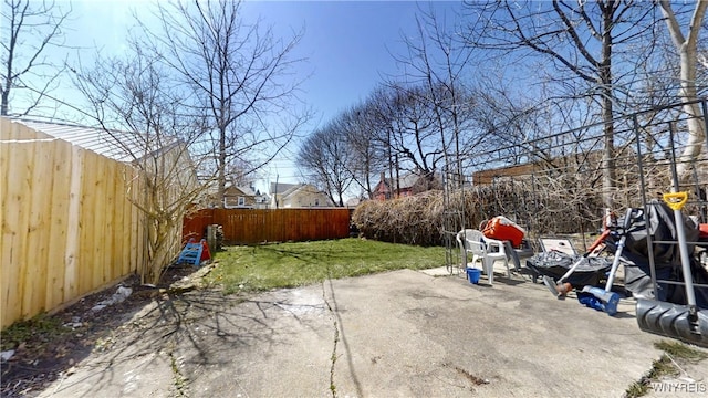 view of yard with a fenced backyard and a patio