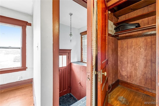 interior space featuring baseboards and wood finished floors