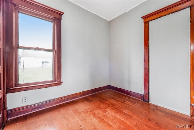 unfurnished room featuring wood finished floors and baseboards