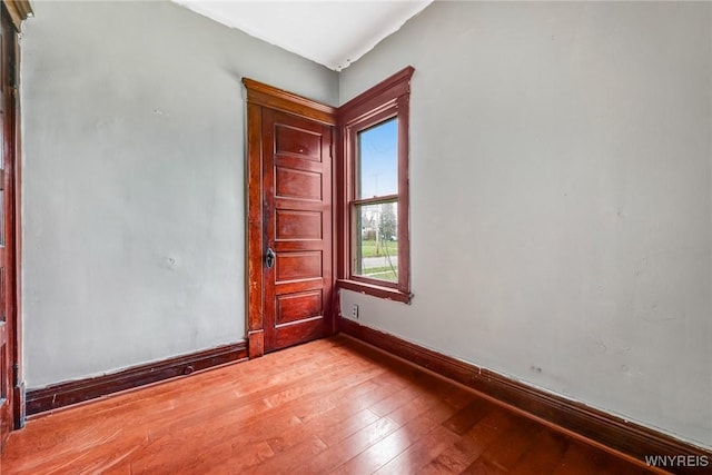 unfurnished room with light wood-style floors and baseboards