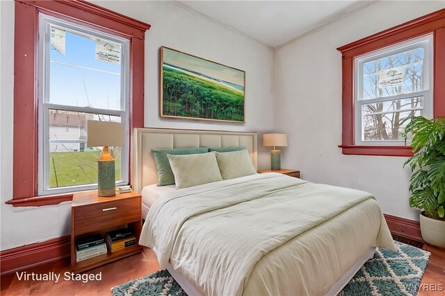 bedroom featuring baseboards and wood finished floors