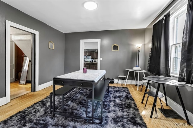 office space featuring baseboards, visible vents, and light wood-type flooring