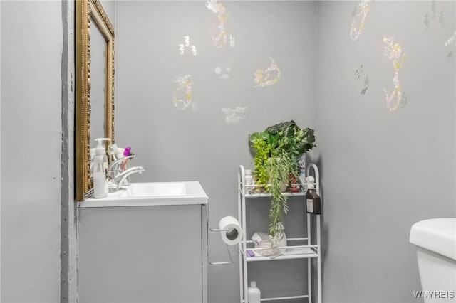 half bath featuring toilet and vanity
