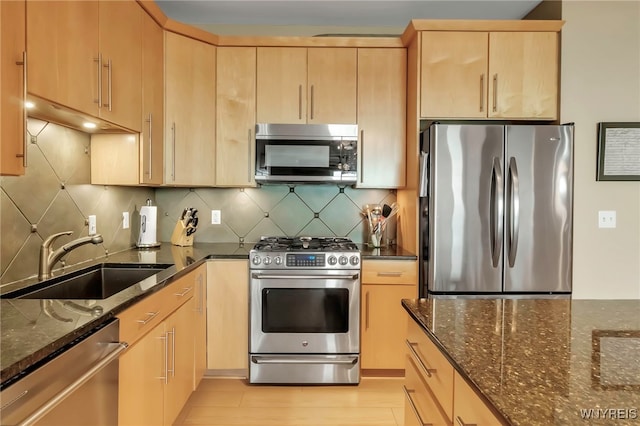 132 Lakefront Blvd Unit 504, Buffalo, NY 14202 - kitchen featuring dark stone counters, light brown cabinets, stainless steel appliances, and a sink