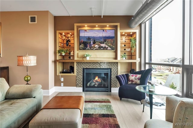 132 Lakefront Blvd Unit 504, Buffalo, NY 14202 - living area with a tile fireplace, wood finished floors, and visible vents