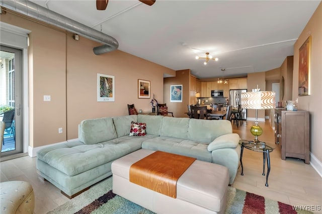 132 Lakefront Blvd Unit 504, Buffalo, NY 14202 - living room with baseboards and a ceiling fan