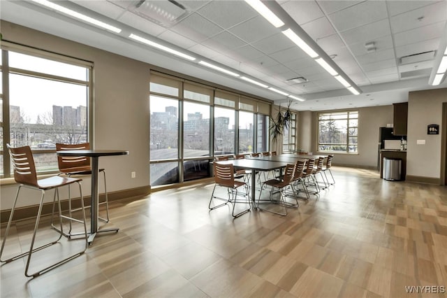 132 Lakefront Blvd Unit 504, Buffalo, NY 14202 - dining space featuring baseboards, a city view, and a paneled ceiling