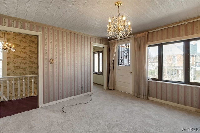 interior space featuring plenty of natural light, carpet floors, and a chandelier