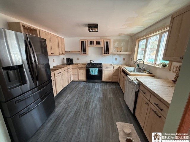 kitchen with a sink, black range with gas cooktop, open shelves, light brown cabinets, and refrigerator with ice dispenser