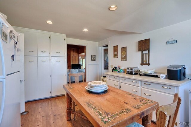 dining area with recessed lighting and light wood finished floors