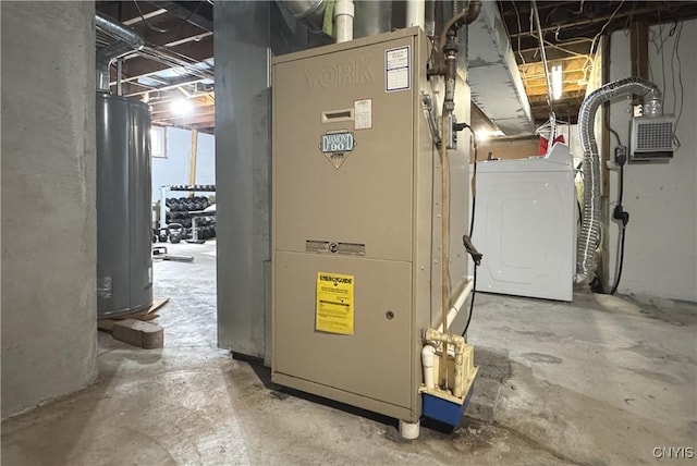utilities featuring heating unit, water heater, and washer / clothes dryer