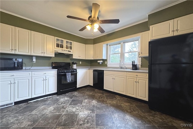 kitchen featuring black appliances, light countertops, under cabinet range hood, and a sink