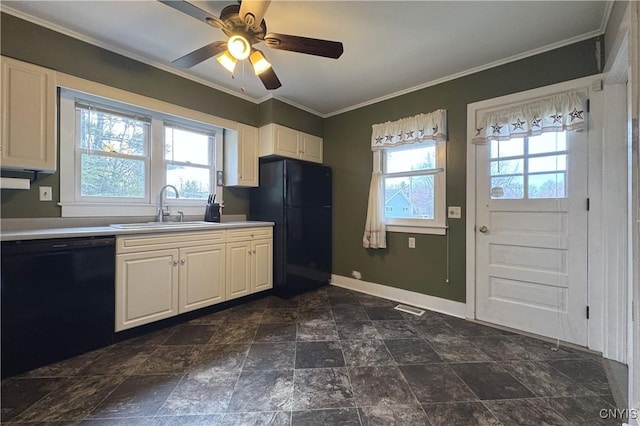 kitchen with black appliances, a wealth of natural light, visible vents, and a sink