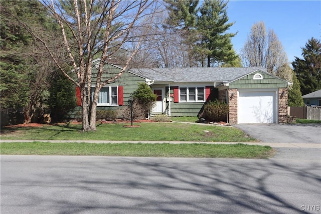 single story home with driveway, a front lawn, and a garage