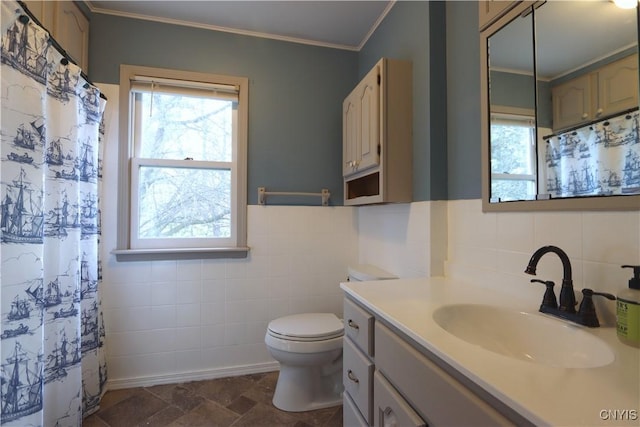 bathroom featuring tile walls, vanity, toilet, ornamental molding, and a shower with shower curtain