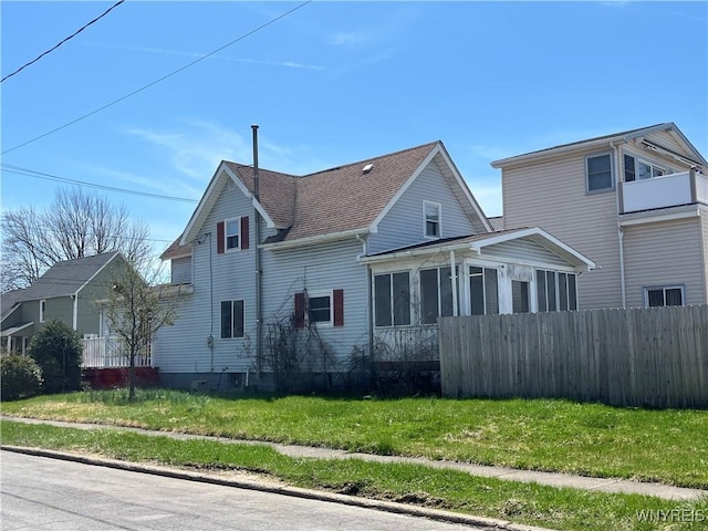 59 Park Ave, Tonawanda-City, NY 14150 - view of front of house featuring a sunroom, a front yard, and fence