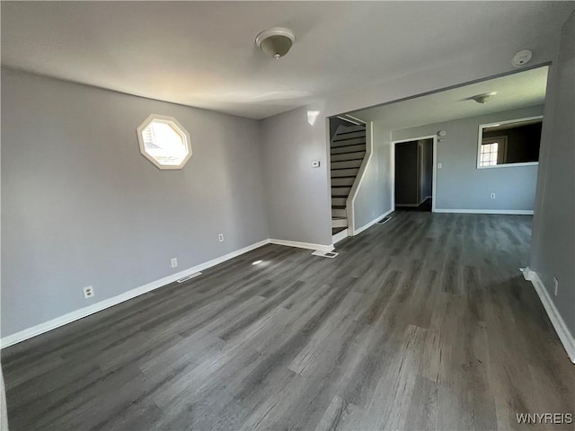 59 Park Ave, Tonawanda-City, NY 14150 - unfurnished room with dark wood finished floors, stairs, visible vents, and plenty of natural light