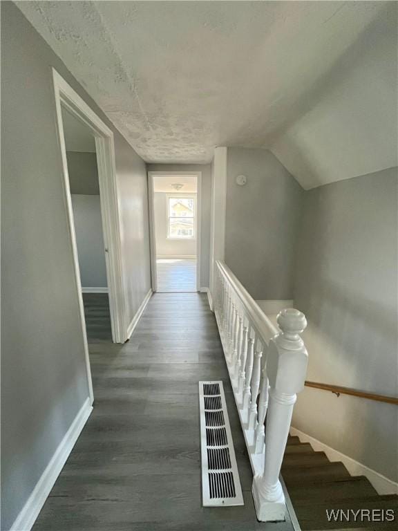 59 Park Ave, Tonawanda-City, NY 14150 - hallway with wood finished floors, visible vents, lofted ceiling, and baseboards
