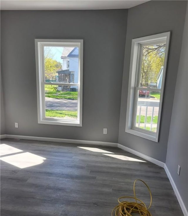 309 Broadway St, Elmira City, NY 14904 - unfurnished room with a wealth of natural light, wood finished floors, and baseboards