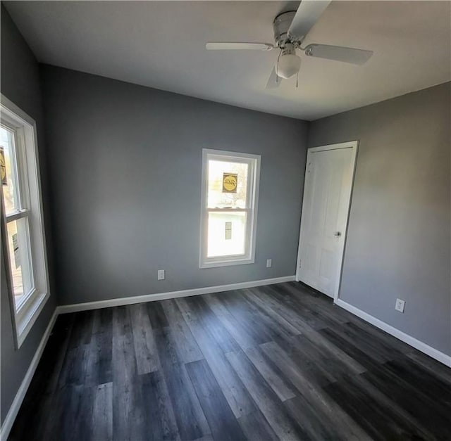 309 Broadway St, Elmira City, NY 14904 - empty room featuring baseboards, dark wood-style floors, and a healthy amount of sunlight