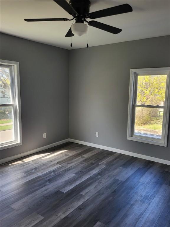 309 Broadway St, Elmira City, NY 14904 - unfurnished room with dark wood finished floors, baseboards, and a healthy amount of sunlight