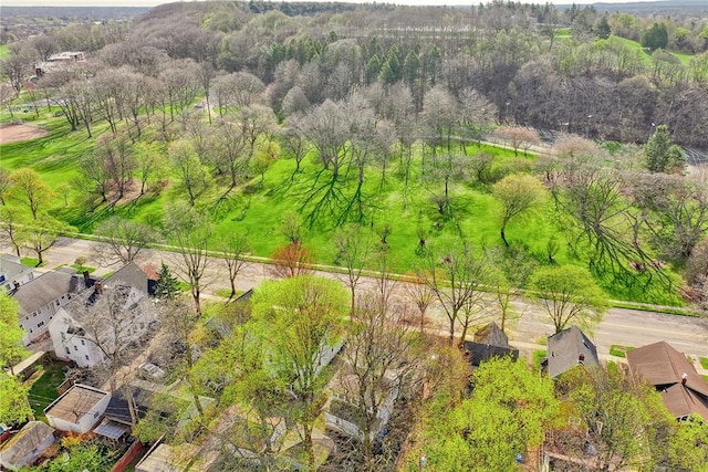 bird's eye view featuring a residential view and a wooded view