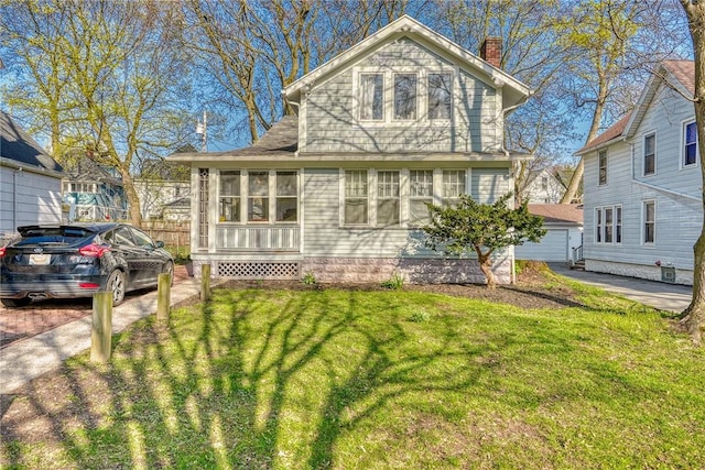 traditional-style home with a chimney and a front yard