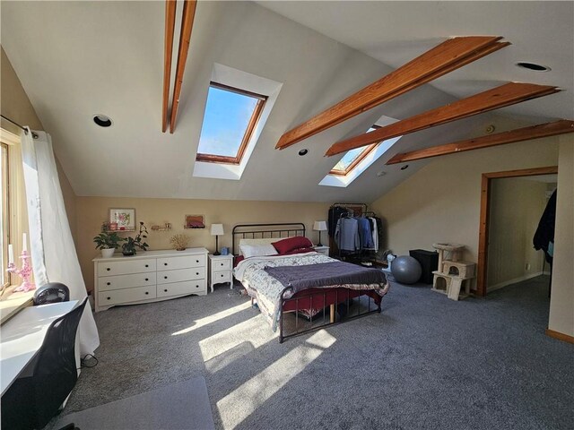 carpeted bedroom featuring lofted ceiling with skylight and multiple windows