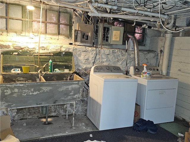 laundry area featuring independent washer and dryer, electric panel, laundry area, and a sink