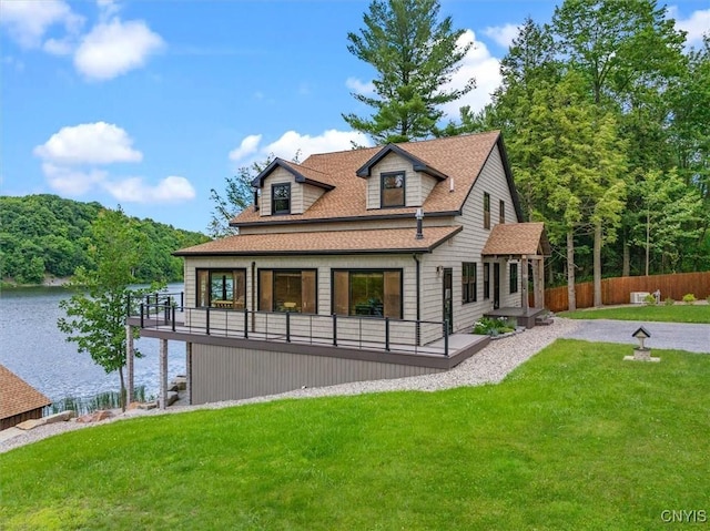 42795 Paynes Lake Camp Rd, Antwerp, NY 13608 - back of property featuring a yard, a shingled roof, a water view, and fence