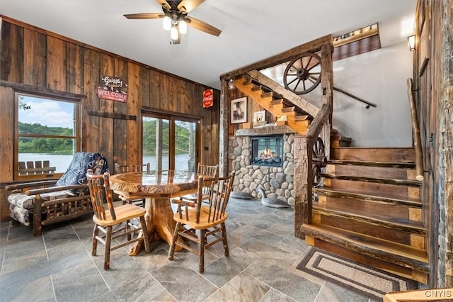 42795 Paynes Lake Camp Rd, Antwerp, NY 13608 - dining area with wooden walls, stairway, stone tile floors, and ceiling fan