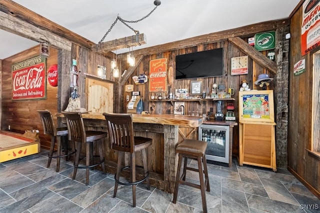 42795 Paynes Lake Camp Rd, Antwerp, NY 13608 - bar featuring stone finish floor, wine cooler, wood walls, and bar
