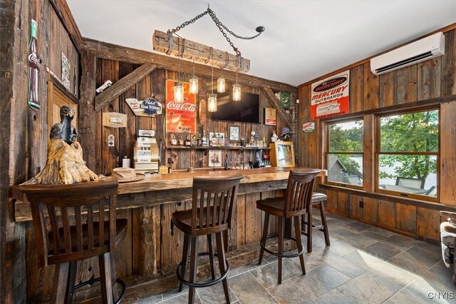 42795 Paynes Lake Camp Rd, Antwerp, NY 13608 - bar with a wall mounted AC, stone tile floors, a bar, and wooden walls