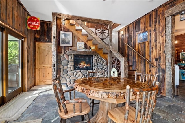 42795 Paynes Lake Camp Rd, Antwerp, NY 13608 - dining area with stone tile floors, stairs, and wooden walls