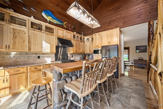 42795 Paynes Lake Camp Rd, Antwerp, NY 13608 - kitchen featuring decorative backsplash, light brown cabinets, under cabinet range hood, and stainless steel fridge with ice dispenser