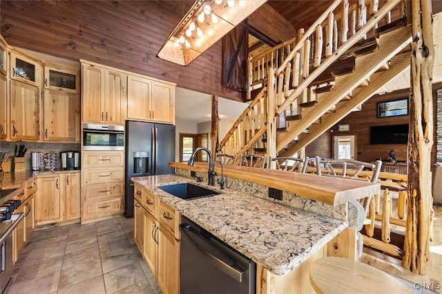 42795 Paynes Lake Camp Rd, Antwerp, NY 13608 - kitchen featuring wood walls, appliances with stainless steel finishes, a sink, and a healthy amount of sunlight