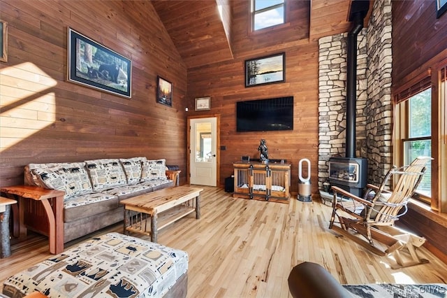 42795 Paynes Lake Camp Rd, Antwerp, NY 13608 - living area featuring high vaulted ceiling, hardwood / wood-style floors, wooden walls, a wood stove, and wooden ceiling