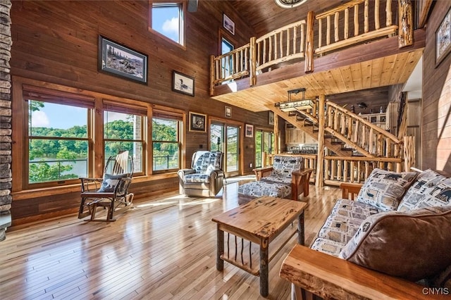 42795 Paynes Lake Camp Rd, Antwerp, NY 13608 - living area featuring high vaulted ceiling, wooden walls, and stairway