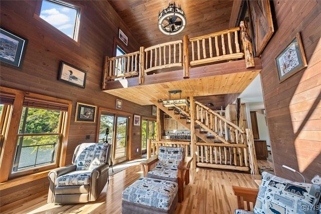 42795 Paynes Lake Camp Rd, Antwerp, NY 13608 - living area with wooden walls, stairs, wood-type flooring, wood ceiling, and high vaulted ceiling