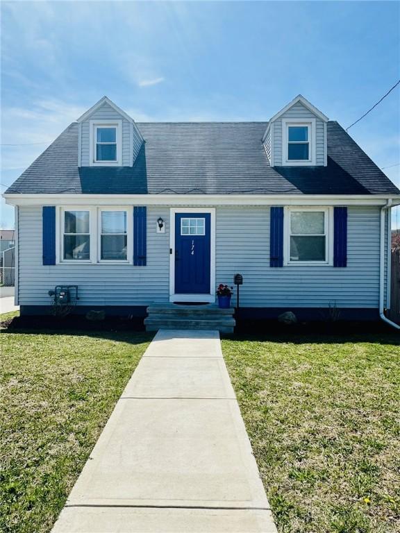 new england style home featuring a front yard