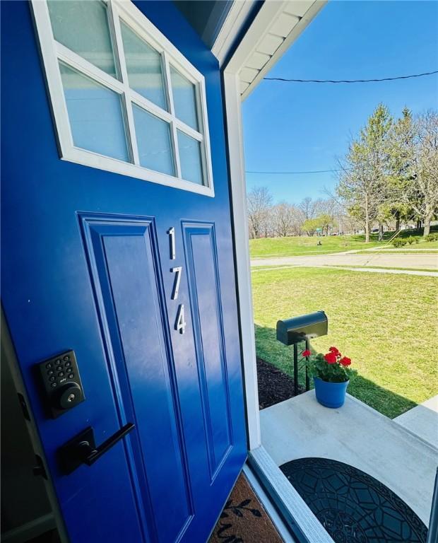 doorway to property featuring a yard