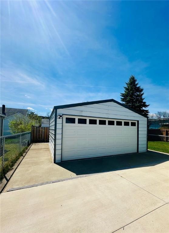 detached garage featuring fence