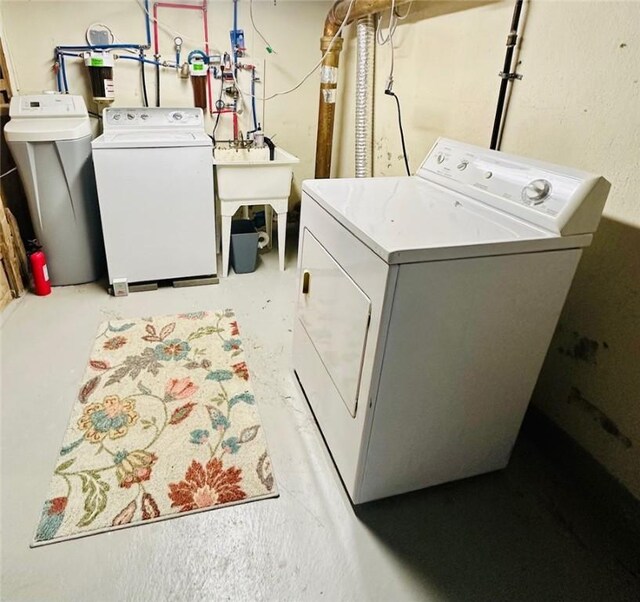 clothes washing area with washer and dryer and laundry area