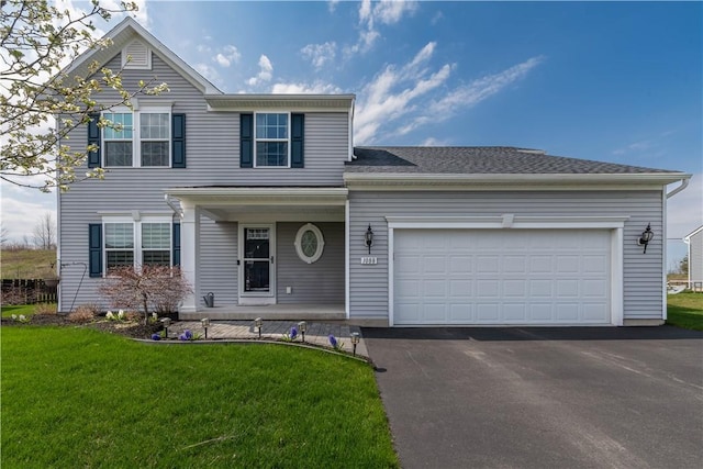traditional home featuring covered porch, aphalt driveway, a front yard, and a garage