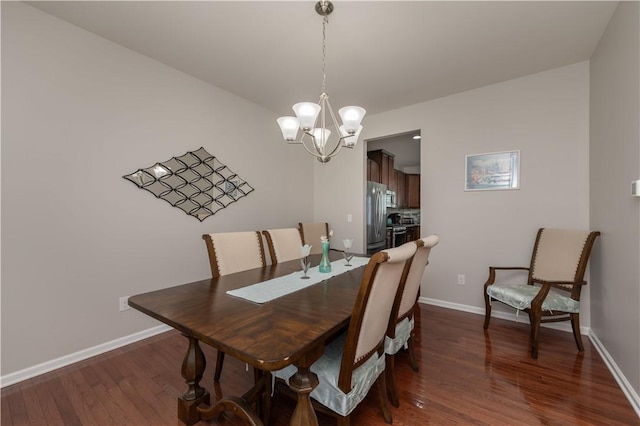 dining area with dark wood finished floors, baseboards, and a chandelier