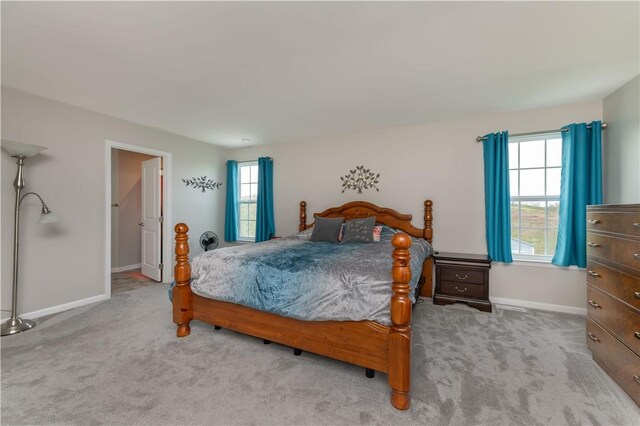 bedroom featuring carpet floors and baseboards